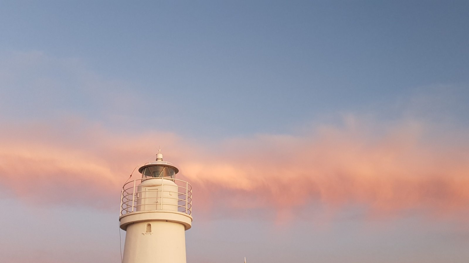 lighthouse and clouds at sunset